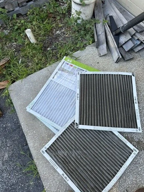 A Temperature Solutions technician checking an outdoor AC condenser unit at a residential property in Lakeland, FL, with diagnostic gauges connected to the refrigerant lines.