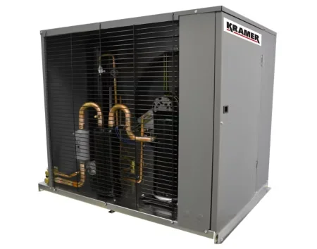 A commercial refrigeration technician from Temperature Solutions completing a walk-in cooler replacement at a commercial facility in Lakeland, FL. The image shows the newly installed refrigeration unit with access panels open during final startup checks.
